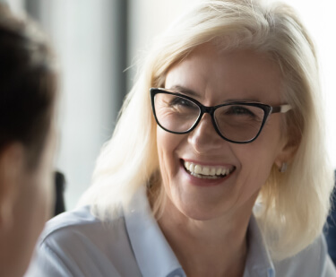 mature woman smiling at colleague